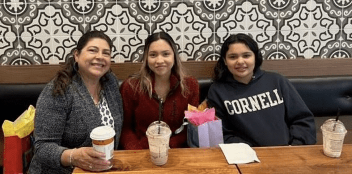 Latina woman and two teens in restaurant